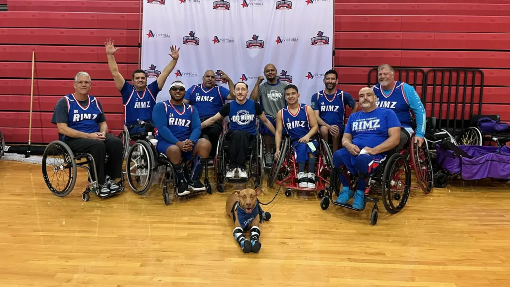 Learn more about Dr Meredith and Dobby pictured here with members of a wheelchair basketball team.